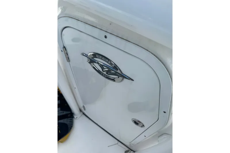 Slide: The Image of 2021 Tidewater 220 LXF boat compartment with sleek chrome emblem. - 12