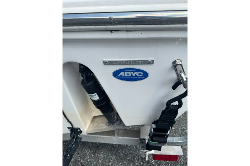 Slide: The Image of 2021 Tidewater 220 LXF boat with ABYC member sticker and visible trailer hitch. - 5