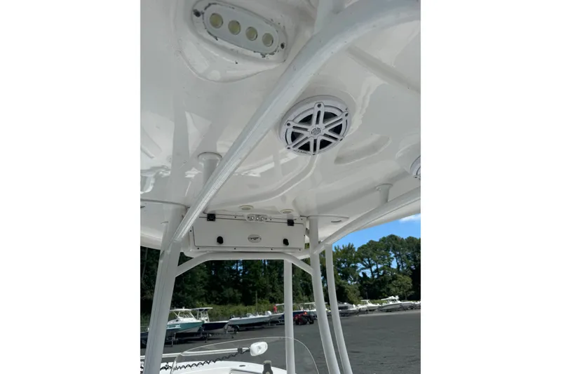 Slide: The Image of 2021 Tidewater 220 LXF boat T-top with speakers and lights, docked outdoors. - 15