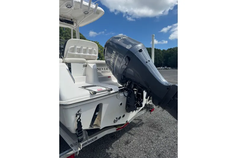 Slide: The Image of 2021 Tidewater 220 LXF boat with Yamaha outboard motor, parked on a trailer. - 4