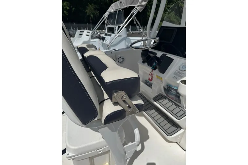 Slide: The Image of 2021 Tidewater 220 LXF boat interior with steering wheel and seating detail. - 7