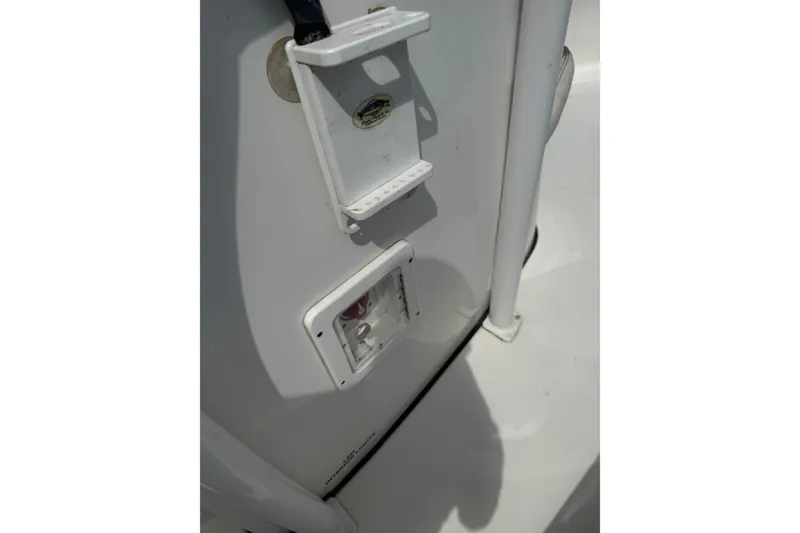 Slide: The Image of 2021 Tidewater 220 LXF boat detail showing electrical outlet and holder. - 16
