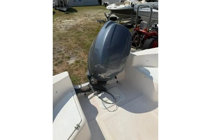 Slide: The Image of 2007 KenCraft 210 Sea King boat with outboard motor, parked on grass. - 19