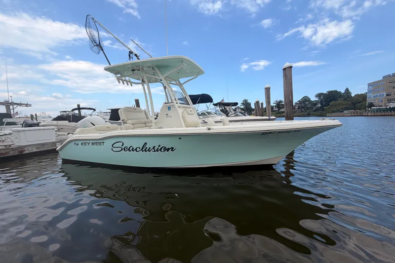 The Image of 2021 Key West 219 FS boat named "Seaclusion" docked in a marina. - 0