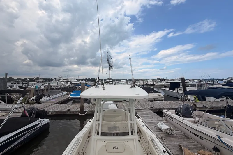 Slide: The Image of 2021 Key West 219 FS boat docked at a marina under a cloudy sky. - 16