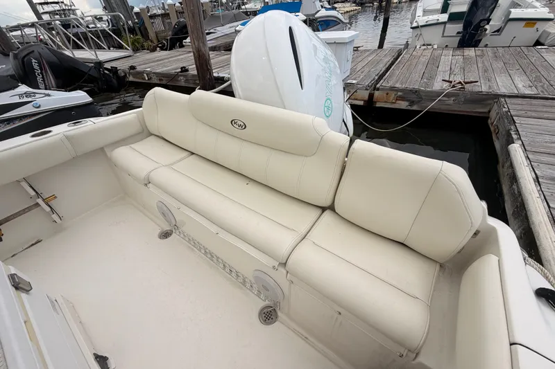 Slide: The Image of 2021 Key West 219 FS boat with beige seating at a marina dock. - 14