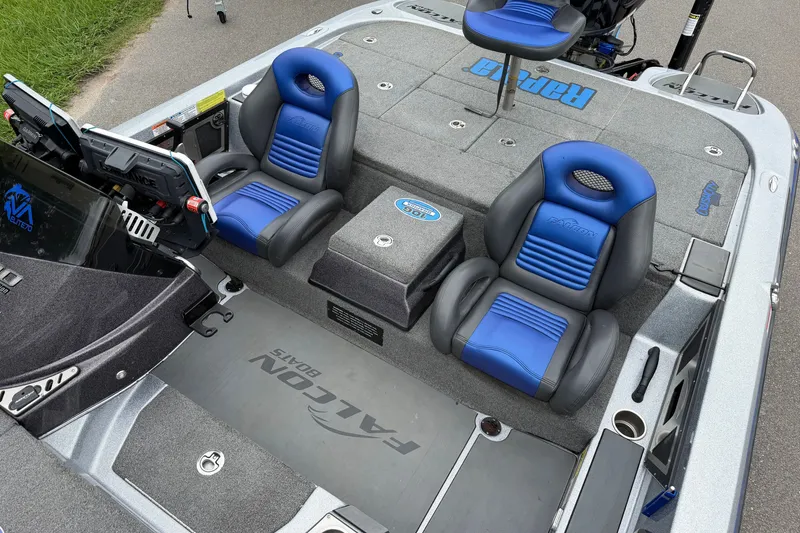 Slide: The Image of Interior of a 2022 Falcon F20 boat with blue and black seating. - 11