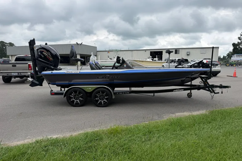 Slide: The Image of 2022 Falcon F20 boat on trailer, parked outdoors near industrial buildings. - 5