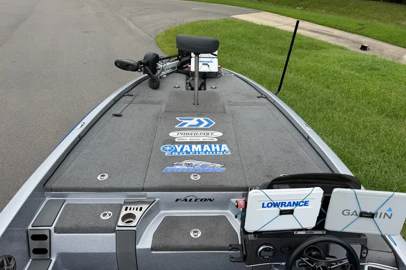 Slide: The Image of 2022 Falcon F20 boat deck with fishing gear, Lowrance and Garmin electronics, parked on a road. - 7