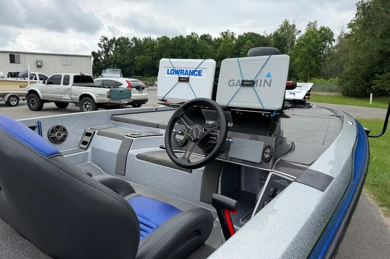 Slide: The Image of 2022 Falcon F20 boat with Garmin and Lowrance navigation systems, parked outdoors. - 9