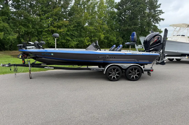 The Image of 2022 Falcon F20 boat on trailer, parked on road with trees in background. - 1