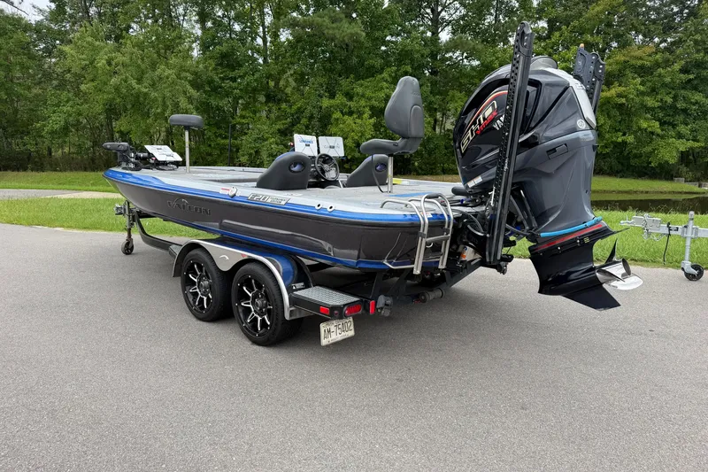 Slide: The Image of 2022 Falcon F20 boat on trailer, parked outdoors with lush green background. - 3