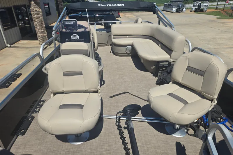 Slide: The Image of 2021 Sun Tracker Bass Buggy 18 DLX pontoon boat with beige seating and spacious deck. - 14