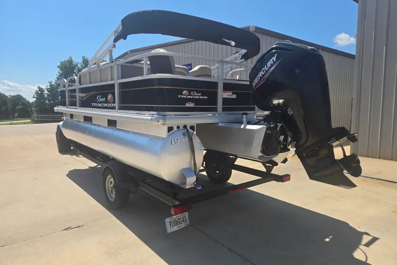 Slide: The Image of 2021 Sun Tracker Bass Buggy 18 DLX pontoon boat with Mercury outboard motor on trailer. - 20