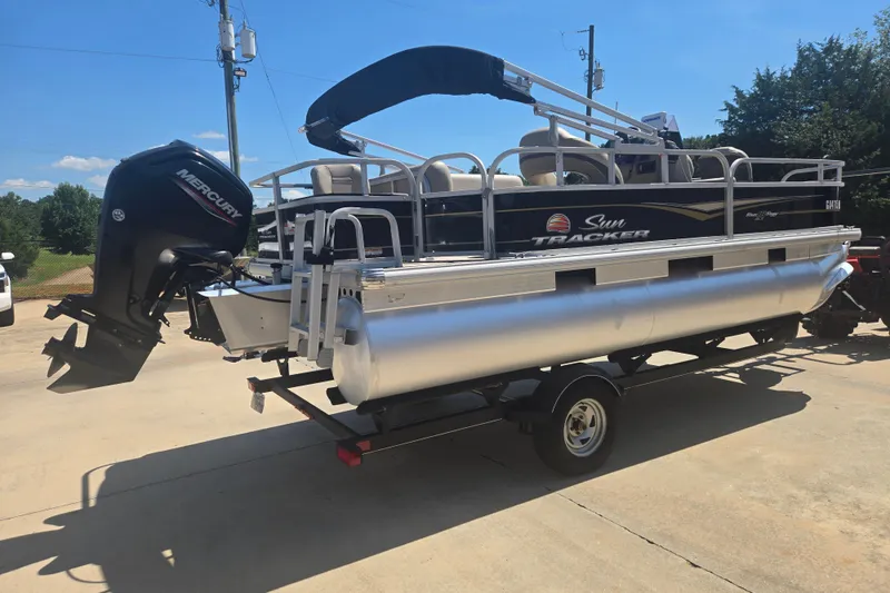 Slide: The Image of 2021 Sun Tracker Bass Buggy 18 DLX pontoon boat with Mercury outboard motor on trailer. - 18