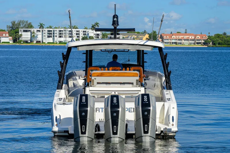 Slide: The Image of 2024 Boston Whaler 42 OUTRAGE boat with triple engines on a calm lake. - 67