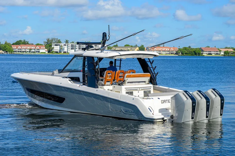 Slide: The Image of 2024 Boston Whaler 42 OUTRAGE boat cruising on a sunny day with four engines. - 66