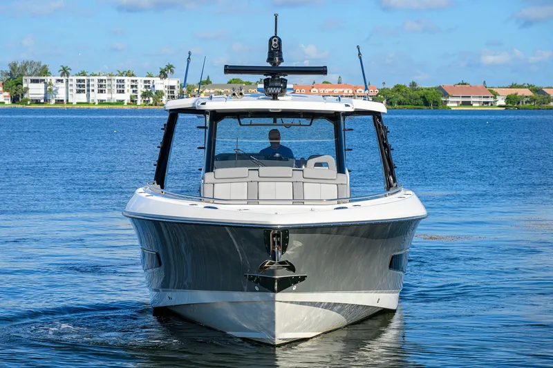 Slide: The Image of 2024 Boston Whaler 42 OUTRAGE boat on calm water, front view. - 62