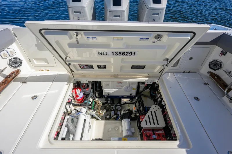 Slide: The Image of 2024 Boston Whaler 42 OUTRAGE engine compartment with open hatch, revealing mechanical components. - 32