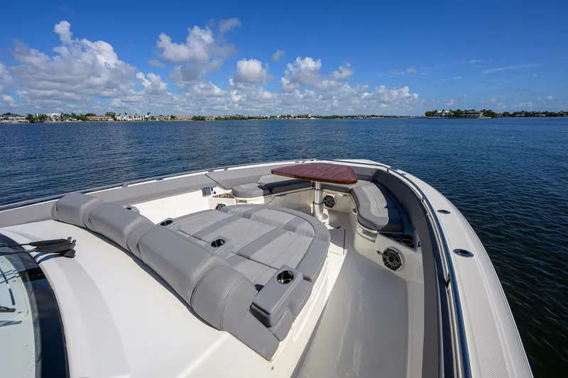 Slide: The Image of 2024 Boston Whaler 42 OUTRAGE boat with luxurious seating on calm waters. - 13
