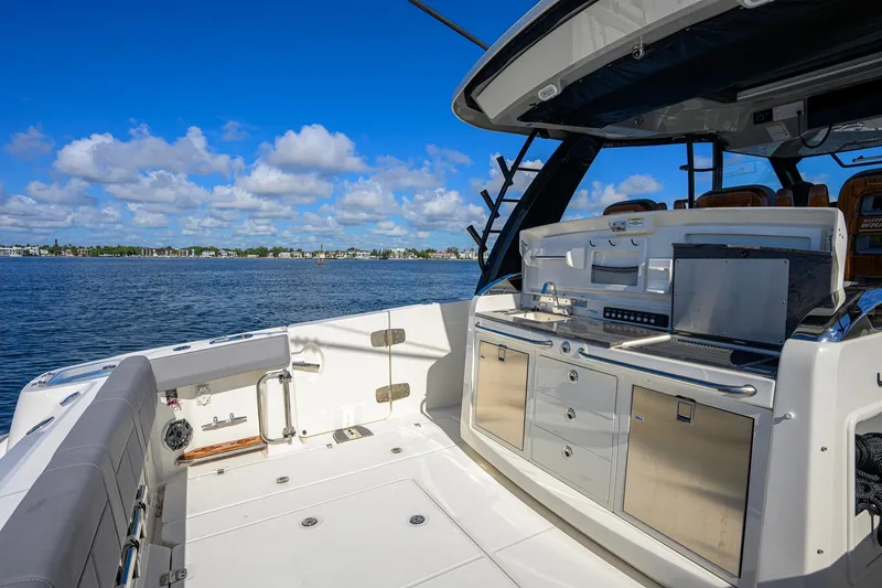 Slide: The Image of 2024 Boston Whaler 42 OUTRAGE boat interior with sleek kitchen setup on open water. - 37