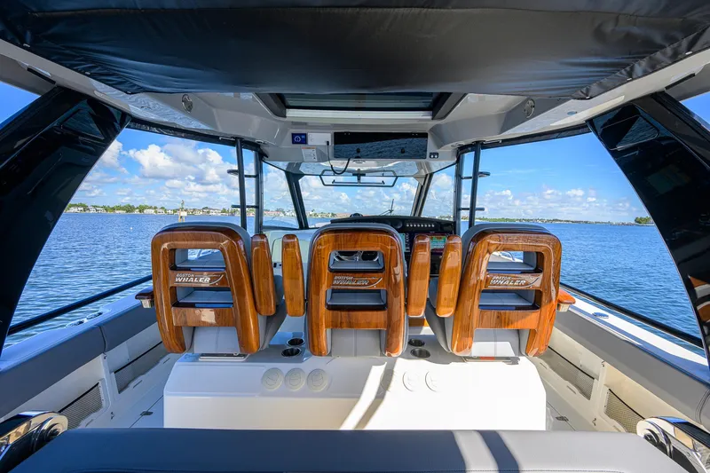 Slide: The Image of 2024 Boston Whaler 42 OUTRAGE interior with luxurious seating and panoramic water view. - 50