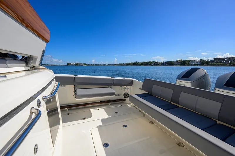 Slide: The Image of 2024 Boston Whaler 42 OUTRAGE boat deck with seating, overlooking serene waters. - 30