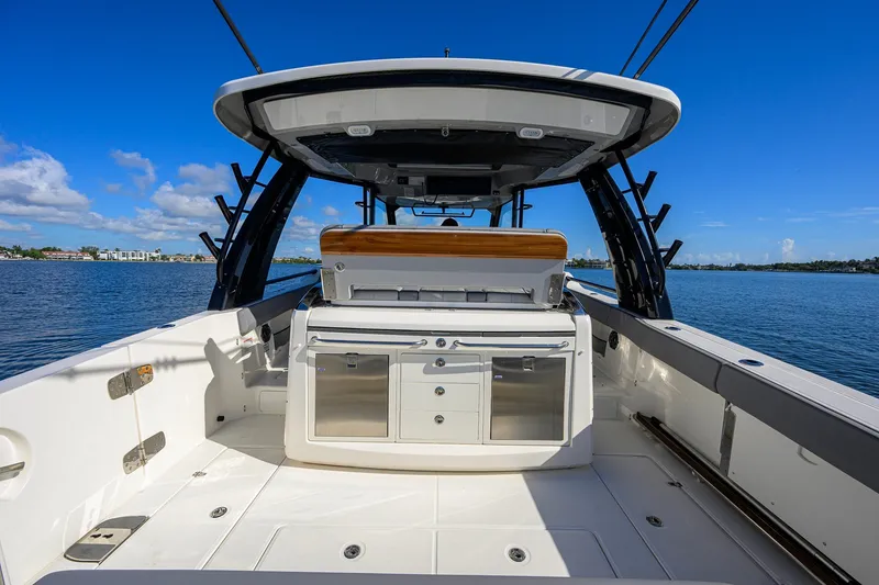Slide: The Image of 2024 Boston Whaler 42 OUTRAGE boat interior with sleek design and ocean backdrop. - 29