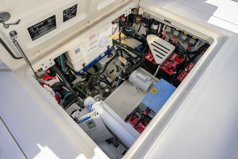 Slide: The Image of Engine compartment of 2024 Boston Whaler 42 OUTRAGE, showcasing batteries and mechanical components. - 34