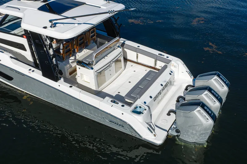 Slide: The Image of 2024 Boston Whaler 42 OUTRAGE boat with quad engines on calm water. - 22