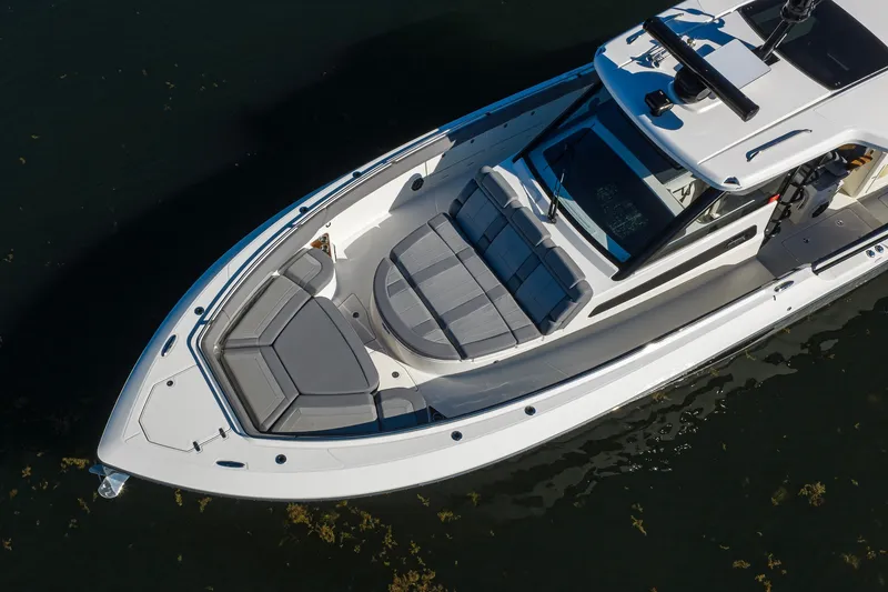 Slide: The Image of 2024 Boston Whaler 42 OUTRAGE boat with sleek design and spacious seating on water. - 3