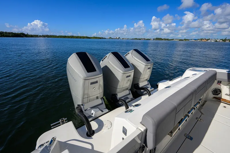 Slide: The Image of 2024 Boston Whaler 42 OUTRAGE with triple outboard engines on calm water. - 46