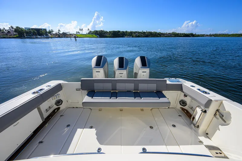 Slide: The Image of 2024 Boston Whaler 42 OUTRAGE boat deck with triple engines on a sunny day. - 25