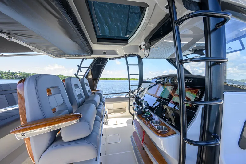 Slide: The Image of Interior view of 2024 Boston Whaler 42 OUTRAGE boat with luxurious seating and advanced navigation controls. - 52