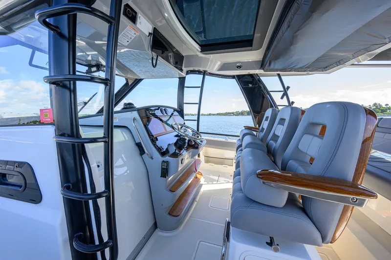 Slide: The Image of Interior view of 2024 Boston Whaler 42 OUTRAGE boat with luxurious seating and helm. - 48