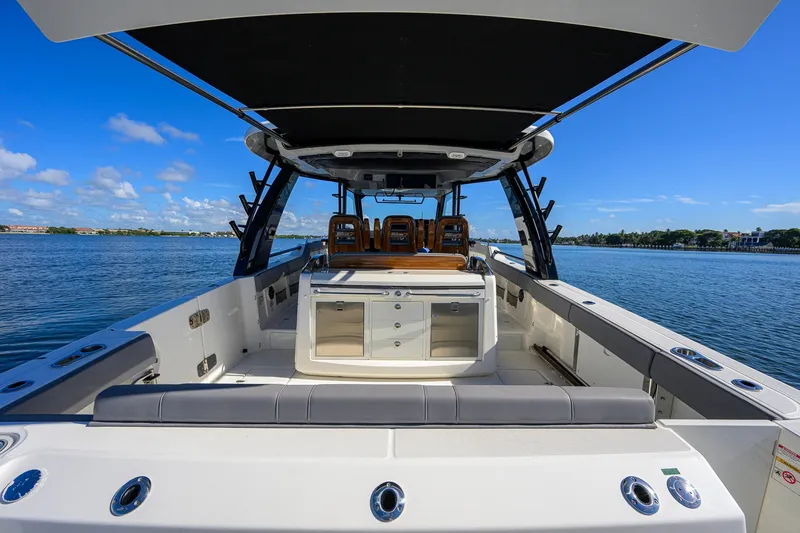 Slide: The Image of 2024 Boston Whaler 42 OUTRAGE boat interior with seating and storage, on a sunny day. - 43
