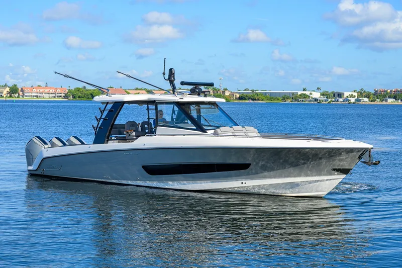 Slide: The Image of 2024 Boston Whaler 42 OUTRAGE boat cruising on a sunny day in calm waters. - 61