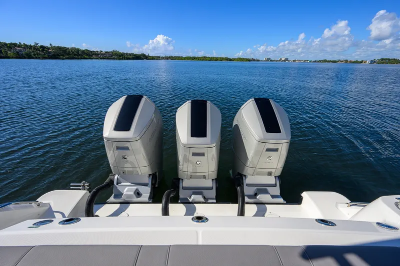 Slide: The Image of 2024 Boston Whaler 42 OUTRAGE with triple outboard engines on calm water. - 45
