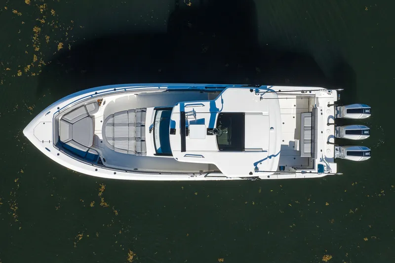 Slide: The Image of Aerial view of 2024 Boston Whaler 42 OUTRAGE boat with triple engines on water. - 56