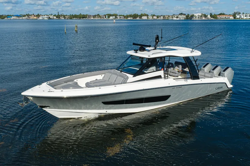 Slide: The Image of 2024 Boston Whaler 42 OUTRAGE boat on calm water, showcasing sleek design and luxury features. - 73