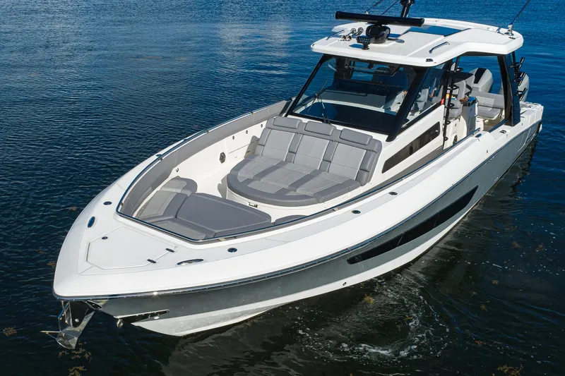 Slide: The Image of 2024 Boston Whaler 42 OUTRAGE boat on water, showcasing sleek design and spacious seating. - 72