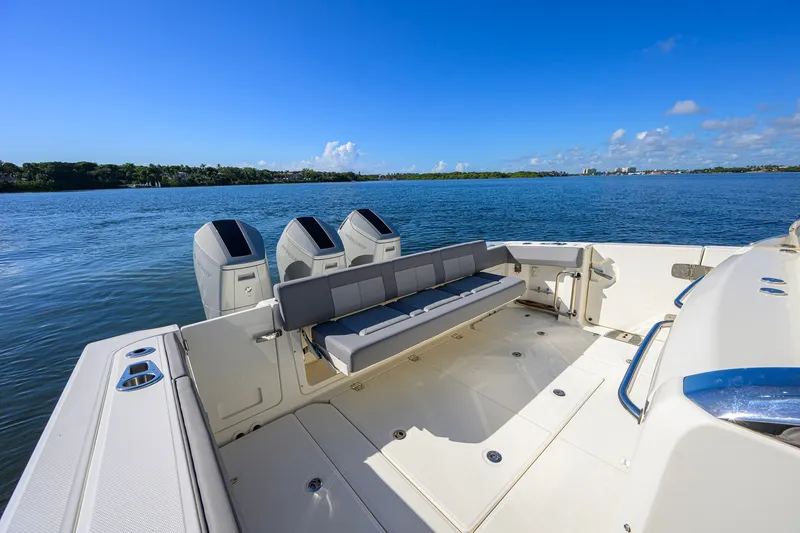 Slide: The Image of 2024 Boston Whaler 42 OUTRAGE boat with triple engines on a sunny day. - 26