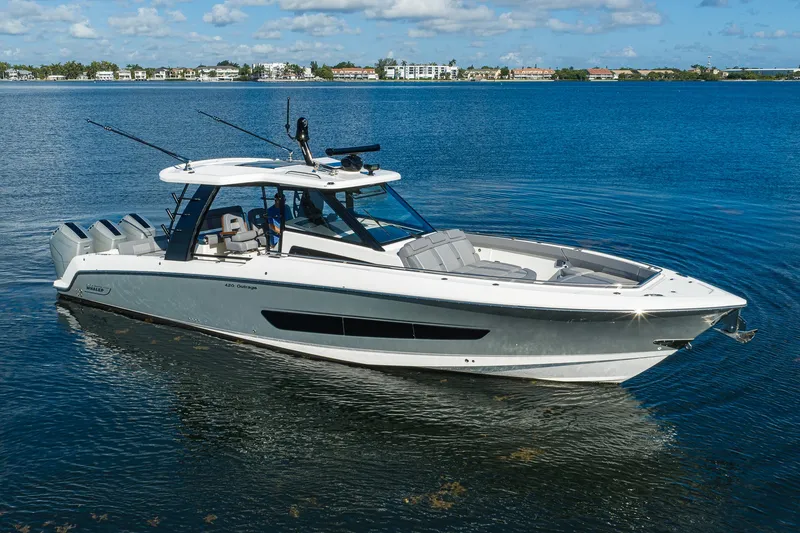 The Image of 2024 Boston Whaler 42 OUTRAGE boat on calm blue water under a clear sky. - 0