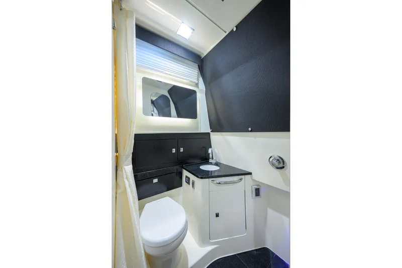 Slide: The Image of Luxurious bathroom interior of 2024 Boston Whaler 42 OUTRAGE boat, featuring modern fixtures and sleek design. - 20