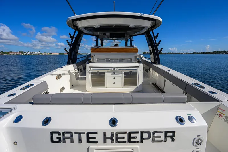 Slide: The Image of 2024 Boston Whaler 42 OUTRAGE boat on water, rear view with seating and storage. - 28