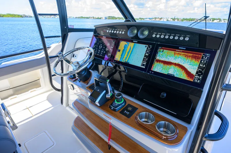 Slide: The Image of 2024 Boston Whaler 42 OUTRAGE helm with advanced navigation displays and controls. - 53
