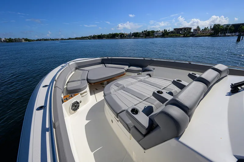 Slide: The Image of 2024 Boston Whaler 42 OUTRAGE boat with luxurious seating on calm water. - 9