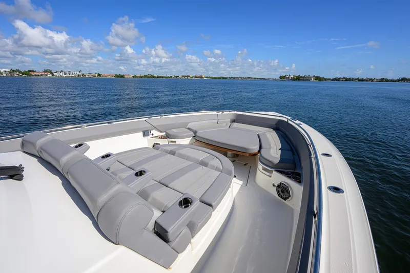 Slide: The Image of 2024 Boston Whaler 42 OUTRAGE boat with luxurious seating on calm waters. - 4