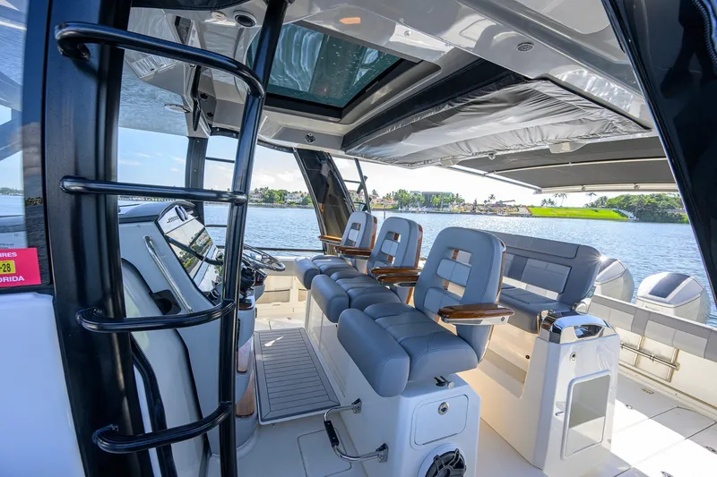 Slide: The Image of Interior view of 2024 Boston Whaler 42 OUTRAGE boat with luxurious seating and helm. - 59
