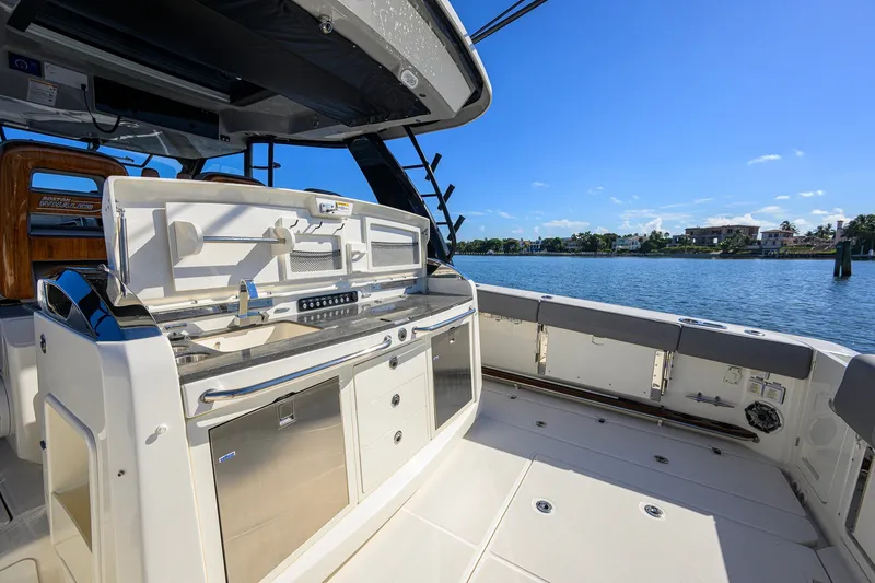 Slide: The Image of 2024 Boston Whaler 42 OUTRAGE boat interior with sleek kitchen setup and waterfront view. - 35